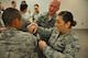 Senior Airman Antonia West, 302nd Logistics Readiness Squadron, simulates how to apply a combat tourniquet on Senior Airman Adrian White, also with the 302nd LRS, while 302nd Aeromedical Staging Squadron personnel observe as part of pre-deployment training at Peterson Air Force Base, Colo., July 16, 2017. More than 150 Air Force Reserve members took part in the training, which included how to respond to an active shooter situation, refreshers on the use of the chemical warfare mission oriented protective posture gear and an overview of self-aid buddy care in a combat environment. (U.S. Air Force photo/1st Lt. Stephen J. Collier)