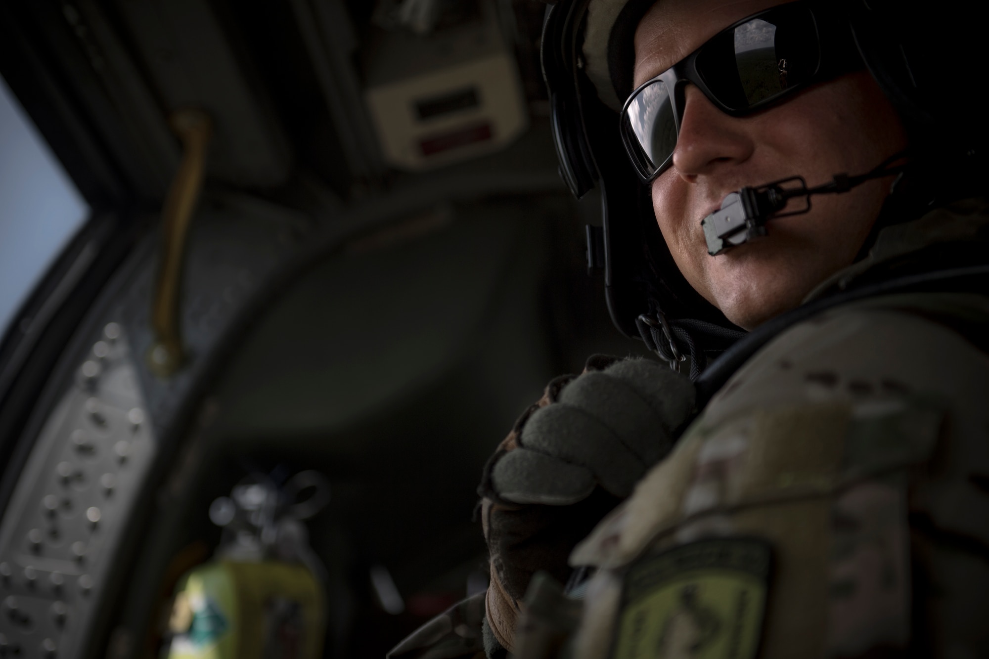 Master Sgt. Zachary Ferguson, 41st Rescue Squadron special missions aviator, rides in the back of an HH-60G Pave Hawk, 7 Aug. 2017, near Dog Island, Fla.