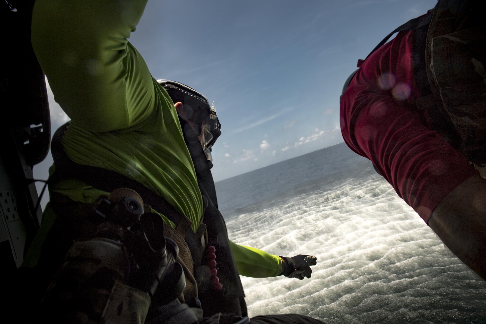 Staff Sgt. Robert, 38th Rescue Squadron pararescueman, directs a fellow PJ to jump into the water, Aug. 7, 2017, near Dog Island, Fla.