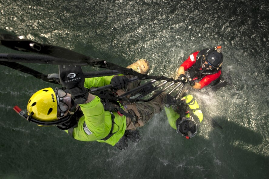 Pararescuemen from the 38th Rescue Squadron climb a ladder into an HH-60G Pave Hawk, Aug. 7, 2017, near Dog Island, Fla.