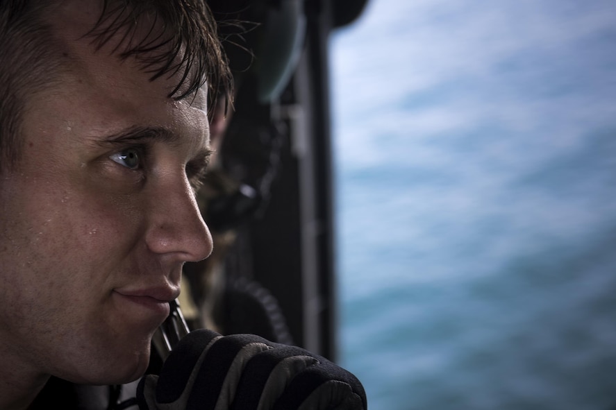 Senior Airman Chase, 38th Rescue Squadron pararescueman, rides in the back of an HH-60G Pave Hawk following water insertion and extraction training, Aug. 7, 2017, near Dog Island, Fla.