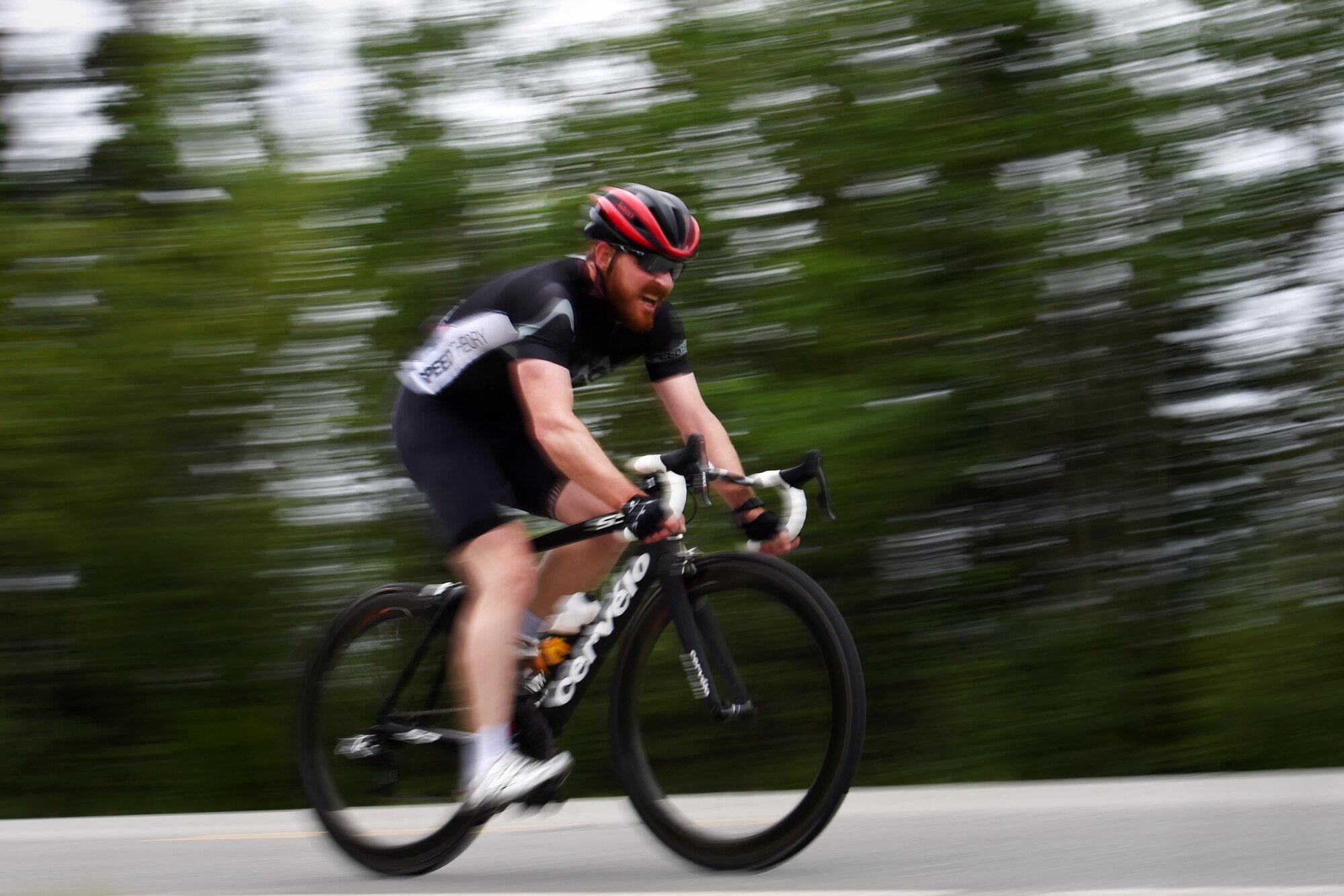 A cyclist streaks down the race path during the Moose Run time-trial race at Joint Base Elmendorf-Richardson, Alaska, Aug. 3, 2017. For more than 15 years, the club has hosted road race events at JBER.