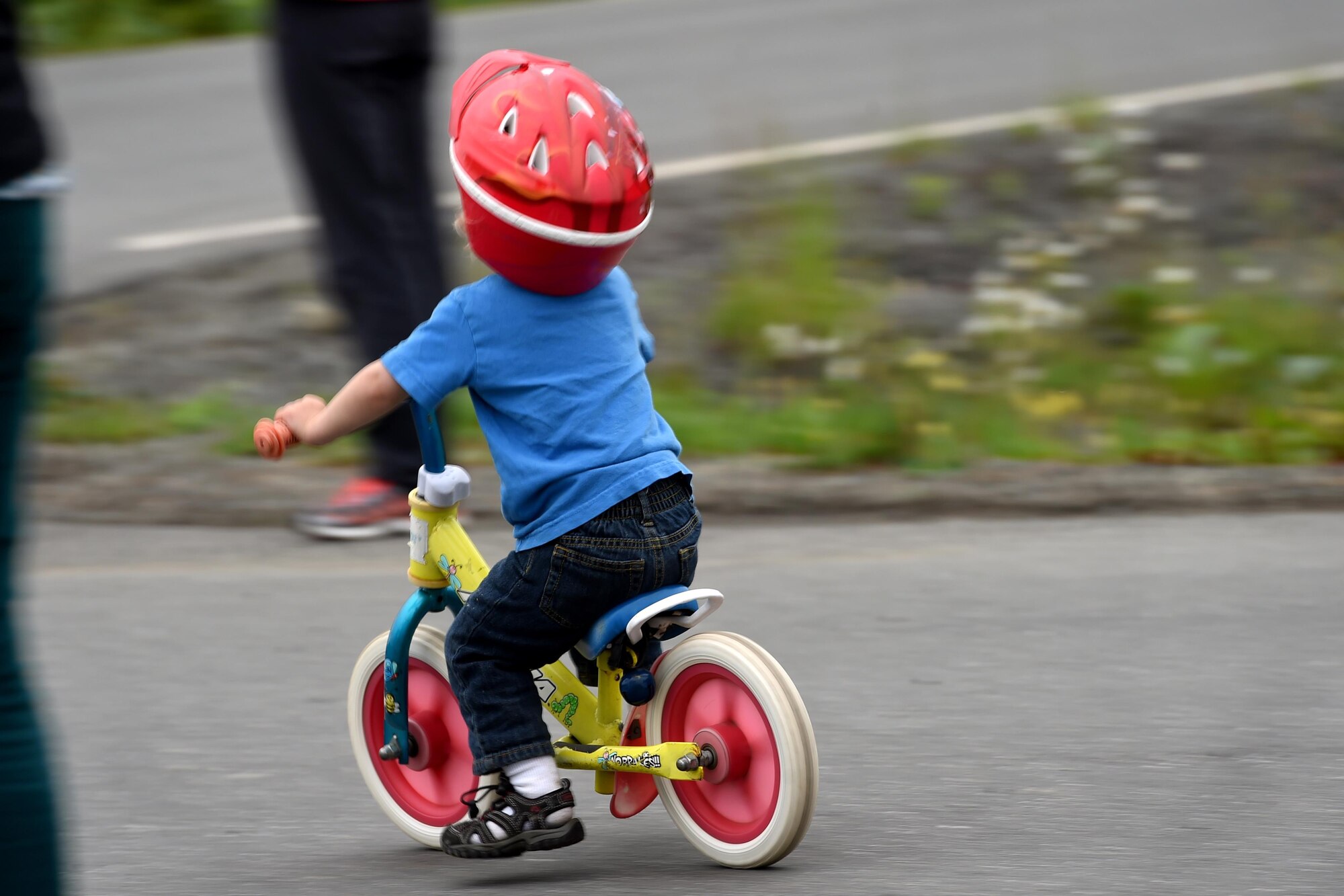Maddox Neff, 2, pushes himself on his bike as spectators await the return of cyclists during the Moose Run time-trial race at Joint Base Elmendorf-Richardson, Alaska, Aug. 3, 2017. For more than 15 years, the club has hosted road race events at JBER.