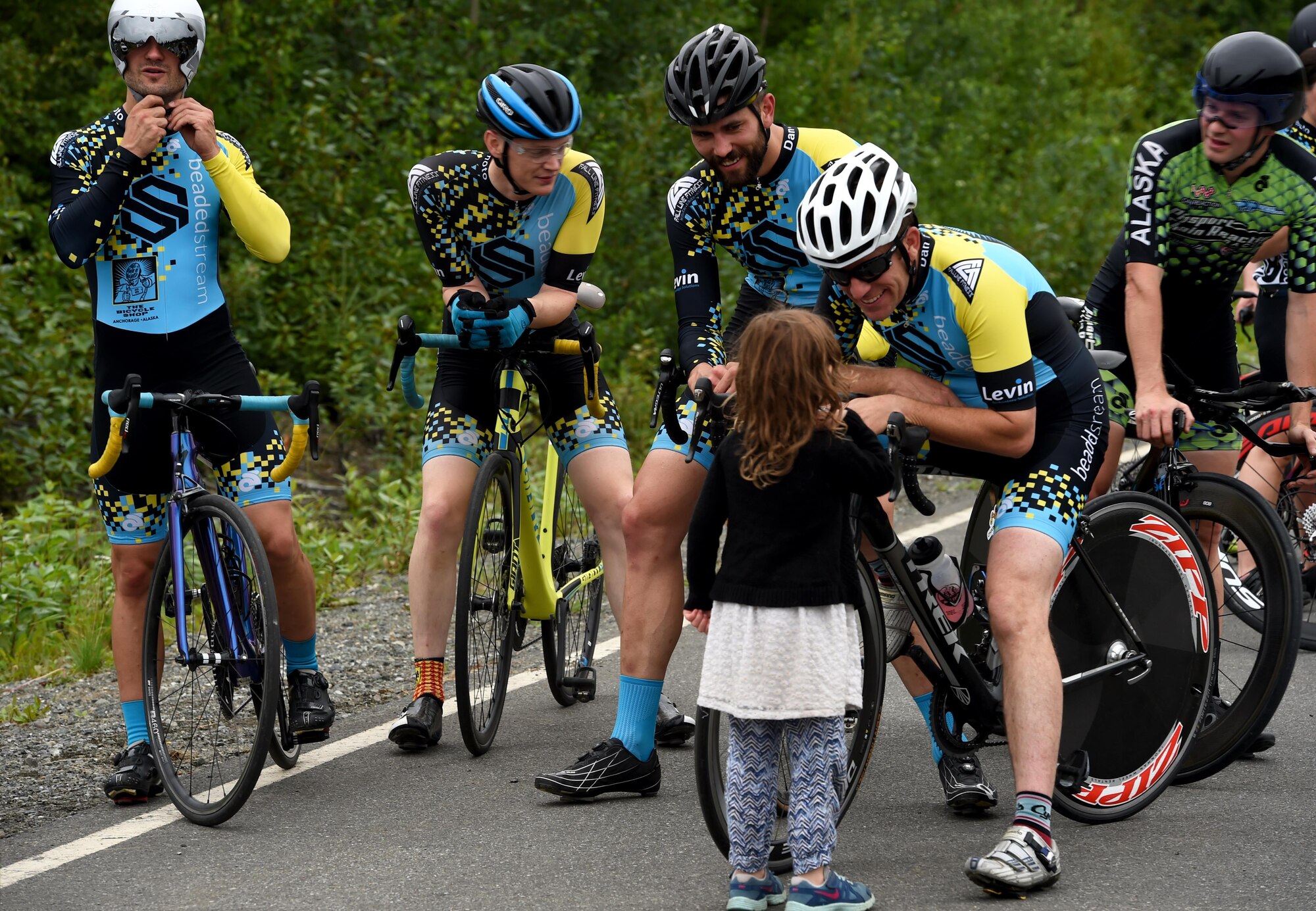 Moose Run time-trial contestants meet with a young spectator following the race at Moose Run Golf Course at Joint Base Elmendorf-Richardson, Alaska, Aug. 3, 2017. For more than 15 years, the club has hosted road race events at JBER.