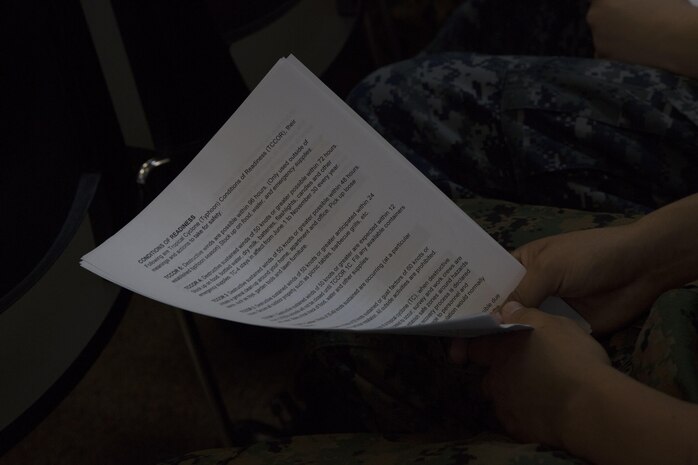 A student holds a handouts during an Emergency Preparation class July 28 at the 3rd Dental Battalion building aboard Camp Foster, Okinawa, Japan.