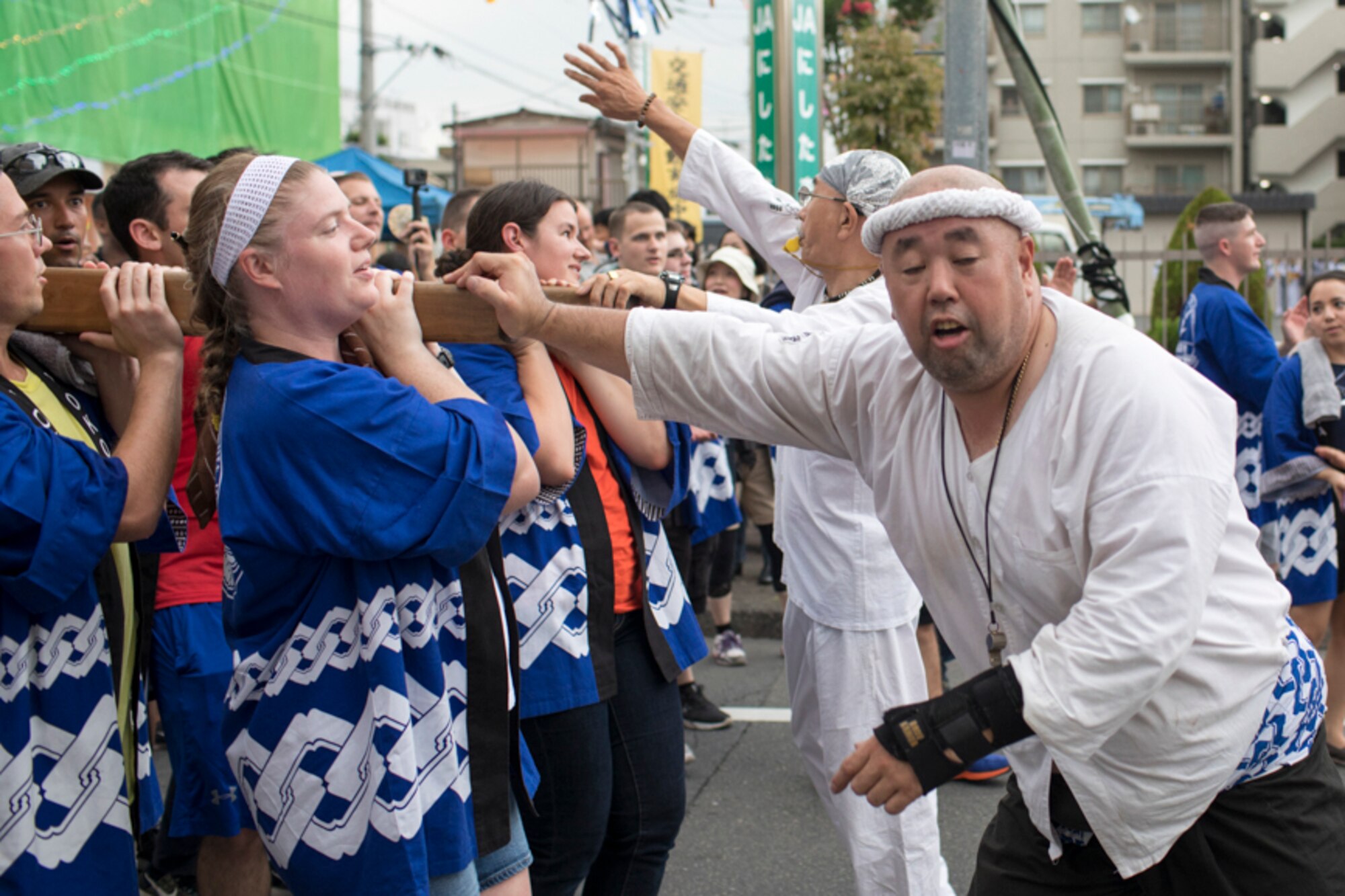 Master Sgt. Eric Moses, 374th Contracting Squadron section chief, carries the wing mikoshi