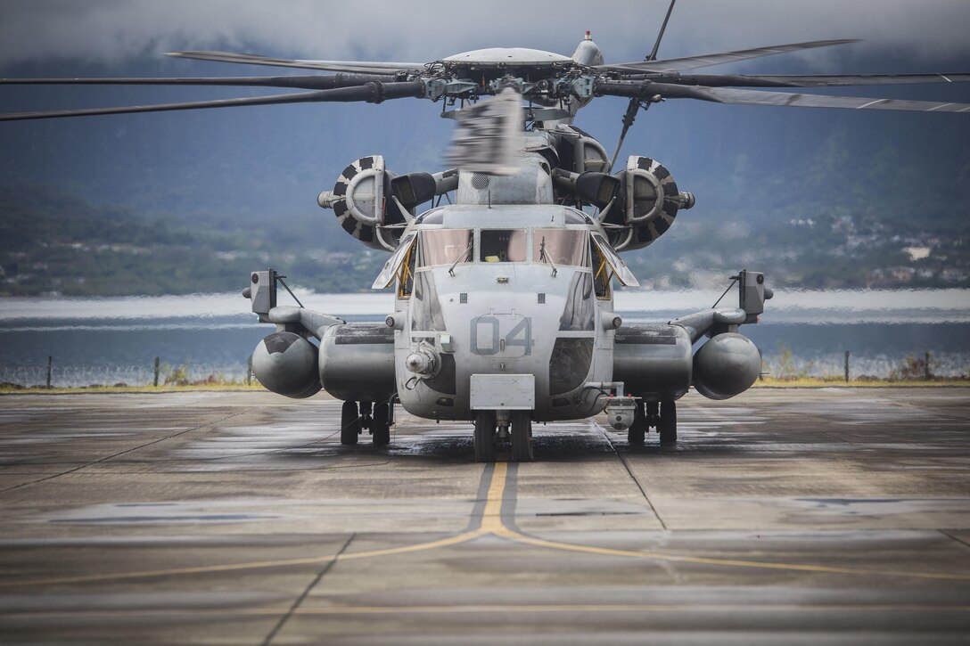 A CH-53E Sea Stallion helicopter assigned to Marine Heavy Helicopter Squadron 463 sits on the flight line aboard Marine Corps Air Station Kaneohe Bay prior to an external lift flight, July 24, 2017. The training improves proficiency for the pilots when moving supplies while Marines on the ground conditioned themselves to safely prepare dual and single load lifts. (U.S. Marine Corps photo by Cpl. Zachary Orr)