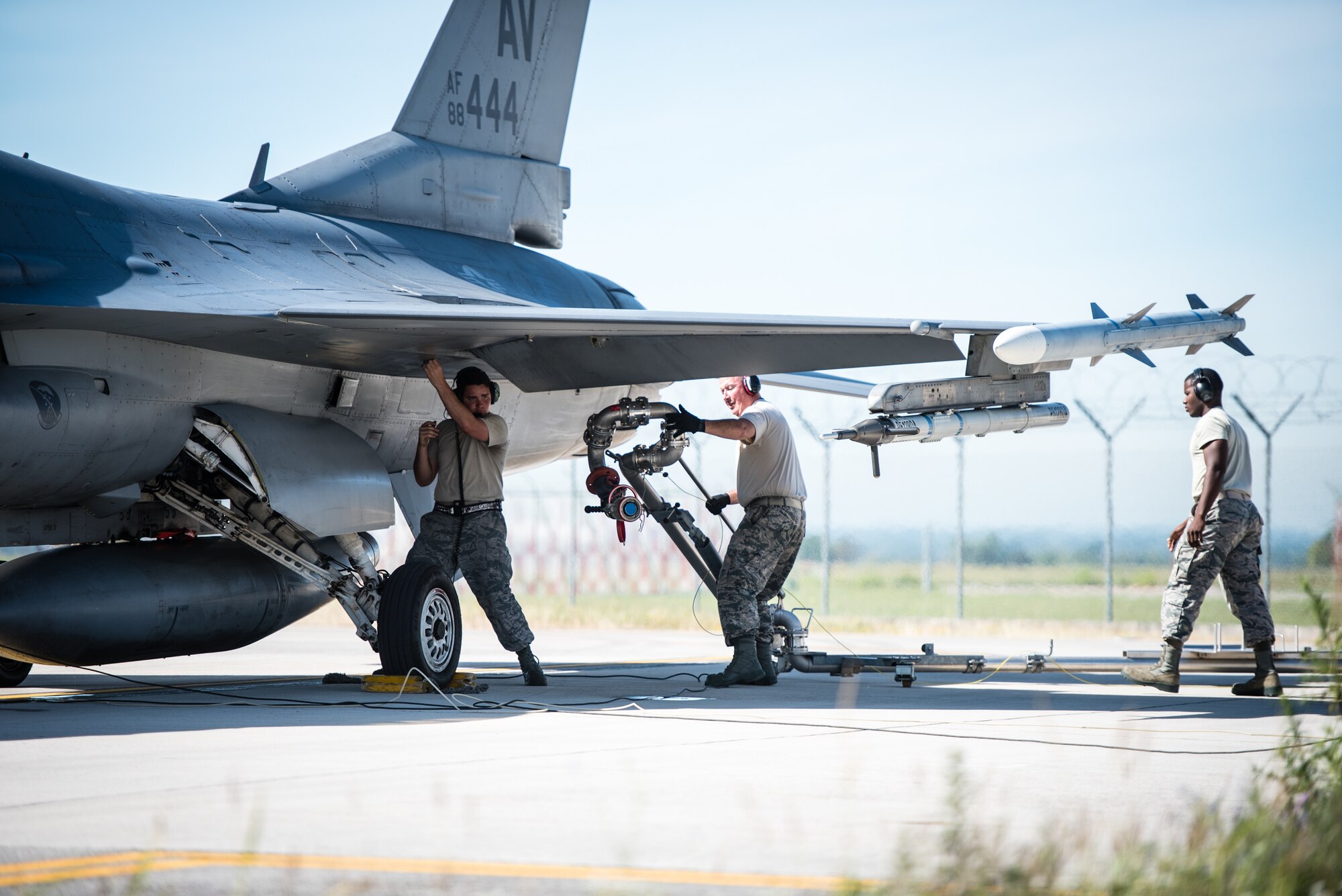 Senior Airman Matthew Ronan, 512th Logistics Readiness Squadron, assists Airmen from the 31st Logistics Readiness Squadron with providing fuel to an F-16S Fighting Falcon, July 28, 2017 at Aviano Air Force Base, Italy.