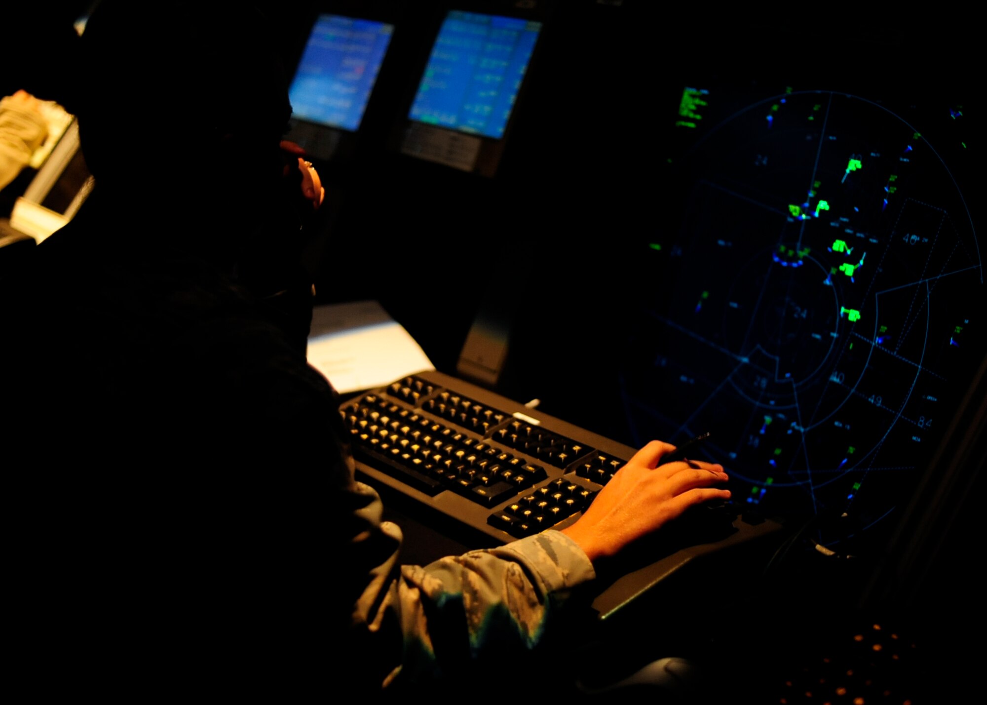 U.S. Air Force Tech. Sgt. Nichole Headley, 8th Operations Support Squadron Airfield Automation Management NCO in-charge, views a display screen showing aircraft in the surrounding airspace at Kunsan Air Base, Republic of Korea, Aug. 2, 2017.