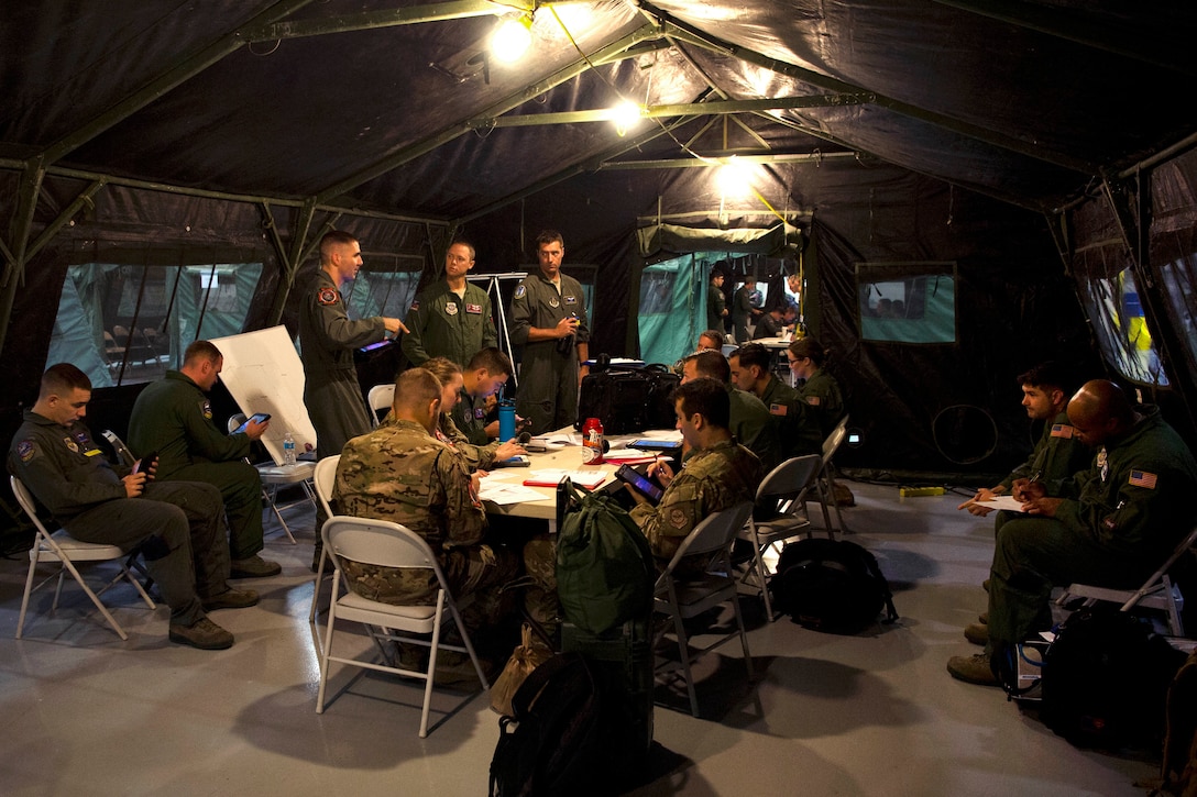 Airmen listen to an intelligence brief, during Exercise Mobility Guardian.