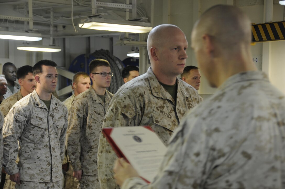Marine Corps Capt. Dakota Herpich, center, is promoted to his current rank while deployed with the 24th Marine Expeditionary Unit serving aboard the amphibious assault ship USS Bataan, July 1, 2017. Herpich is the officer in charge of the unit's law enforcement detachment. Marine Corps photo by Capt. Jordan Cochran