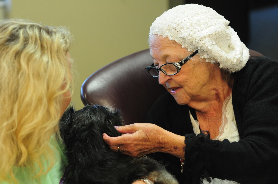 Betty Witcher, a resident of a local senior care home, pets Frannie during a visit from Frankie & Andy's Place July 27, 2017, Winder, Ga. Frannie is a senior dog that was rescued by Frankie & Andy's Place and visits senior citizens to liven up their day.
