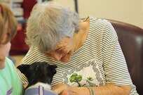 Sarah Pruette, a resident of a local senior care home, pets Lucy during a visit from Frankie & Andy's Place July 27, 2017, Winder, Ga. Lucy is a senior dog that was rescued by Frankie & Andy's Place and visits senior citizens to liven up their day.