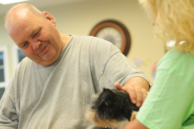 Ricky Mauldin, a resident of a local senior care home, pets Frannie during a visit from Frankie & Andy's Place July 27, 2017, Winder, Ga. Frannie is a senior dog that was rescued by Frankie & Andy's Place and visits senior citizens to liven up their day.