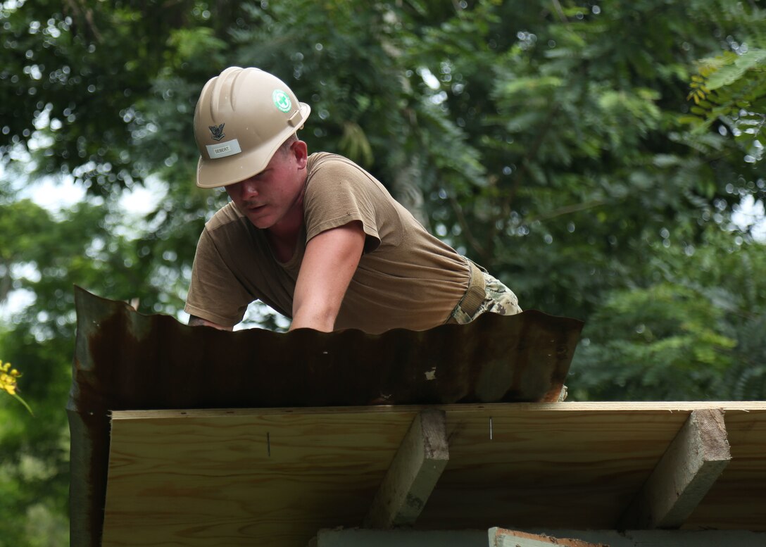 A U.S. Navy Sailor builds a roof for Escuela Rural Mixta Luz Infantil, a local elementary school, during a Southern Partnership Station 17 community relations project