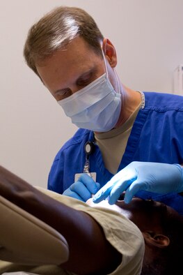 U.S. Air Force Reserve Lt. Col. Kyle Wendfeldt, a 913th Aerospace Medical Squadron dentist, performs a dental examination during the Unit Training Assembly weekend at Little Rock Air Force Base, Ark., Aug. 5, 2017. The medical squadron helps ensure 913th Airlift Group Airmen are medically qualified to deploy worldwide. (U.S. Air Force photo by Master Sgt. Jeff Walston/Released)