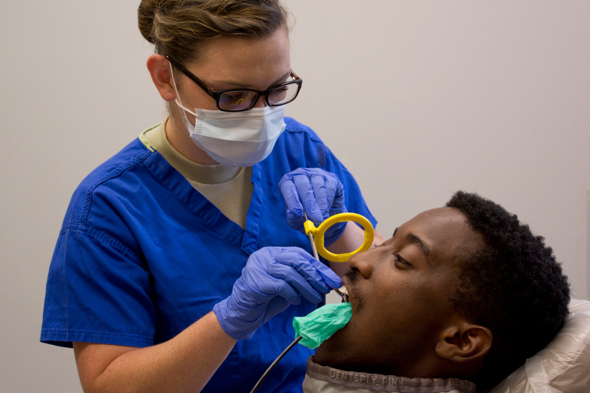 U.S. Air Force Reserve Senior Airman Carlie Creech, a 913th Aerospace Medical Squadron dental technician, prepares Senior Airman Eddie Lee Higgins, an air transportation journeyman assigned to the 96th Aerial Port Squadron, for an Xray during the Unit Training Assembly weekend at Little Rock Air Force Base, Ark., Aug. 5, 2017. The medical squadron helps ensure 913th Airlift Group Airmen are medically qualified to deploy worldwide. (U.S. Air Force photo by Master Sgt. Jeff Walston/Released)
