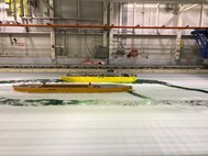 A model icebreaker demonstrates its maneuverability during a test at the National Research Council of Canada's facility in St. Johns, Newfoundland, on July 26, 2017. The test showcased the progress made on the testing and evaluation of design models for the U.S. Coast Guard's icebreaker acquisition program, which is being supported by an international, multiagency team including engineers from Naval Surface Warfare Center, Carderock Division. (U.S. Navy photo by Steven Ouimette/Released)