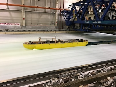 A model icebreaker (yellow) maneuvers to free a beset vessel during a test at the National Research Council of Canada's facility in St. Johns, Newfoundland, on July 26, 2017. The test showcased the progress made on the testing and evaluation of design models for the U.S. Coast Guard's icebreaker acquisition program, which is being supported by an international, multiagency team including engineers from Naval Surface Warfare Center, Carderock Division. (U.S. Navy photo by Stephen Minnich/Released)