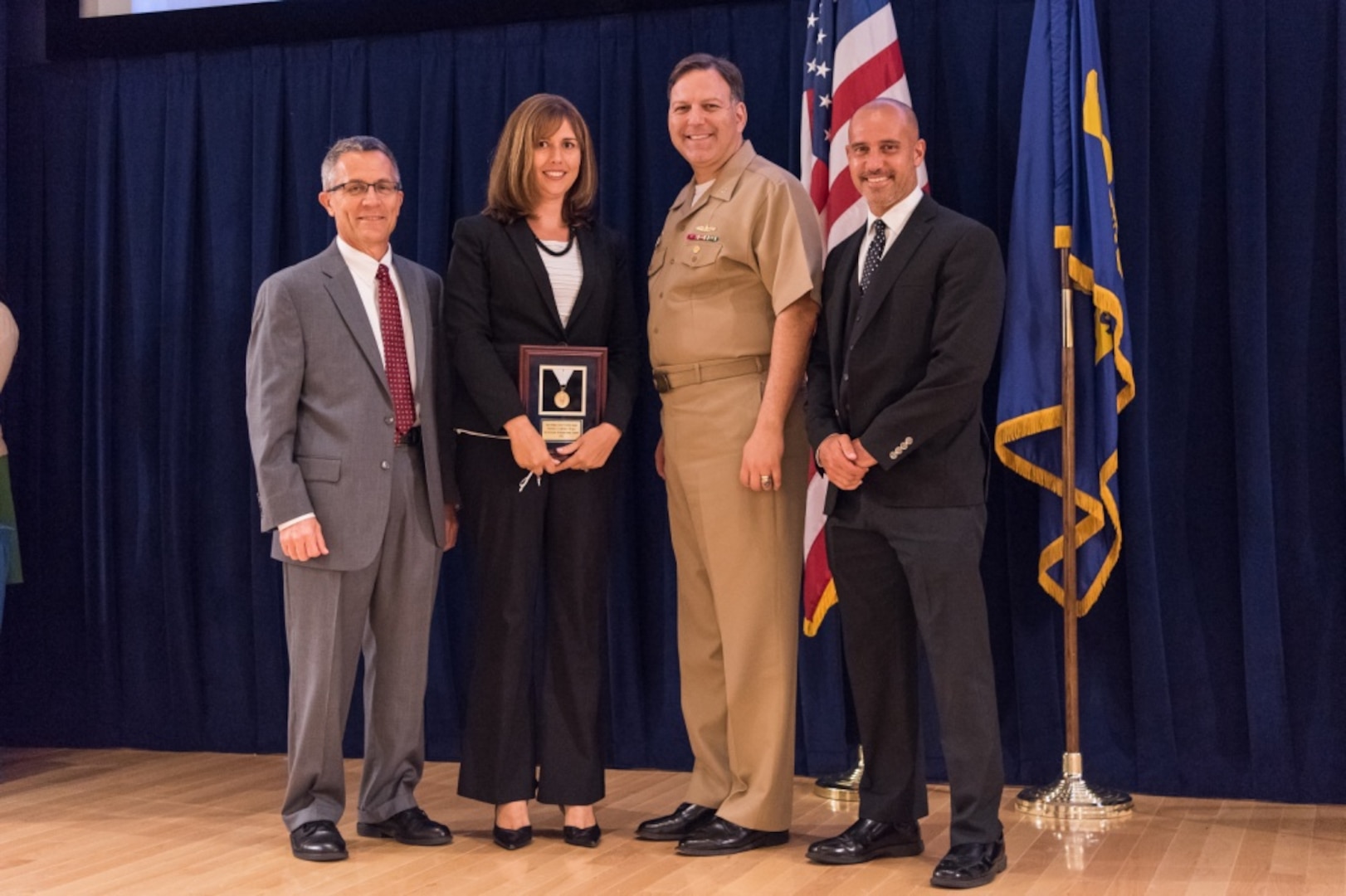 Christine Mitchell, a contracting officer with Carderocks Contracting and Acquisition Department, receives the Rear Adm. Grace M. Hopper Award for excellence in organizational support at the Naval Surface Warfare Center, Carderock Division Honor Awards ceremony Aug. 1, 2017, in West Bethesda, Md. From left to right: Technical Director Dr. Tim Arcano, Mitchell, Commanding Officer Capt. Mark Vandroff and Contracting and Acquisition Department Head Tariq Al-Agba. (U.S. Navy photo by Jake Cirksena/Released)