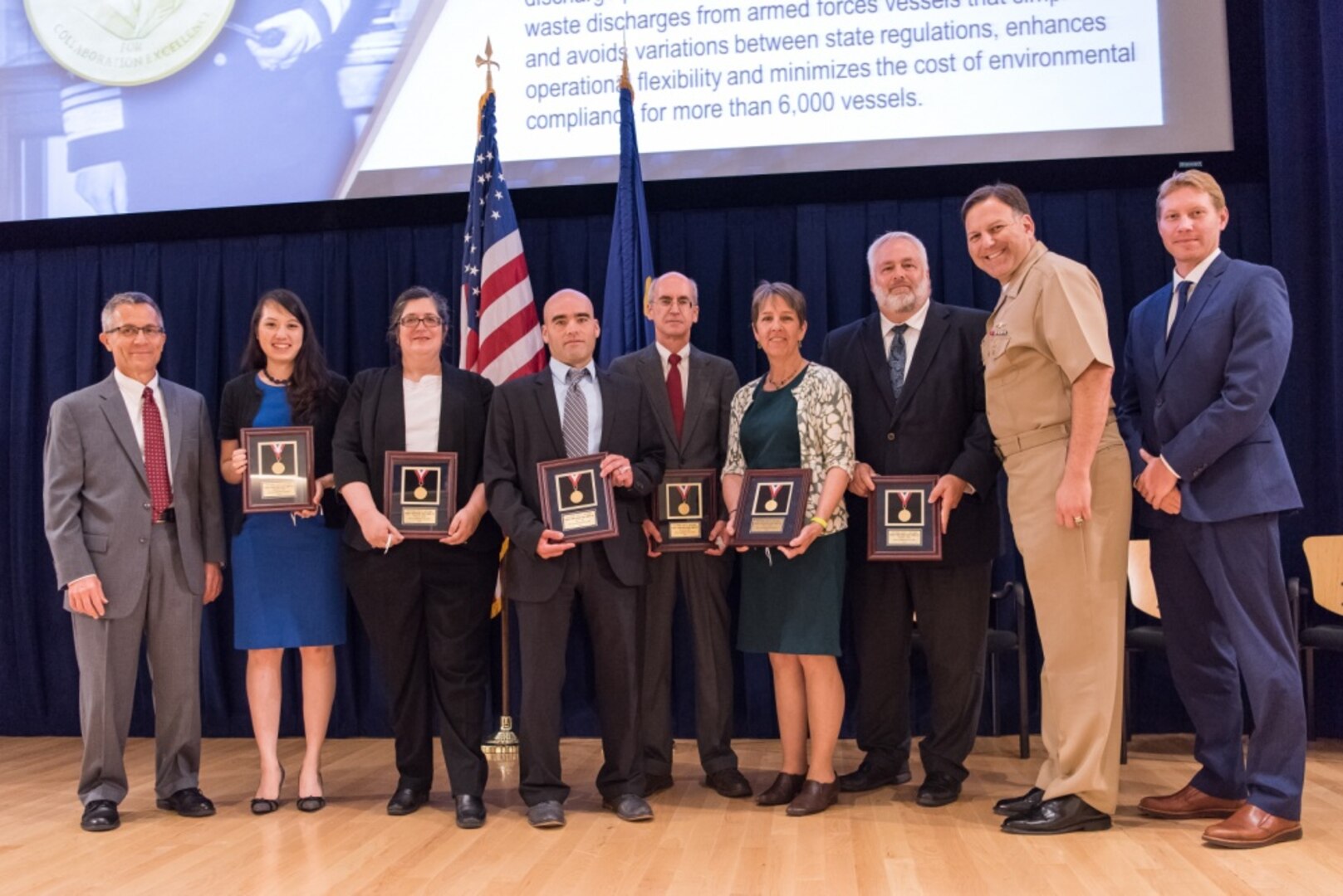 The Uniform National Discharge Standards (UNDS) Team receives the Vice Adm. Emory S. Land Award for collaboration excellence at the Naval Surface Warfare Center, Carderock Division Honor Awards ceremony Aug. 1, 2017, in West Bethesda, Md. From left to right: Technical Director Dr. Tim Arcano; Christine Park; Rachel Jacobs; Toby Cole; Dr. Eric Holm; Rita Schuh; Gordon Smith; Commanding Officer Capt. Mark Vandroff; and Survivability, Structures, Materials and Environmental Department Head (Acting) Ross Hempel. Not pictured are Cindy Chen and Leslie DeMichele. (U.S. Navy photo by Jake Cirksena/Released)