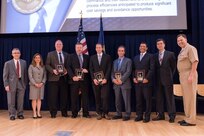 The Warfare Center Test and Evaluation Directors Collaboration Working Group receives the Donald F. McCormack Award, which recognizes a small group for collaboration excellence across the Warfare Centers, at the Naval Surface Warfare Center, Carderock Division Honor Awards ceremony Aug. 1, 2017, in West Bethesda, Md. (U.S. Navy photo by Jake Cirksena/Released)