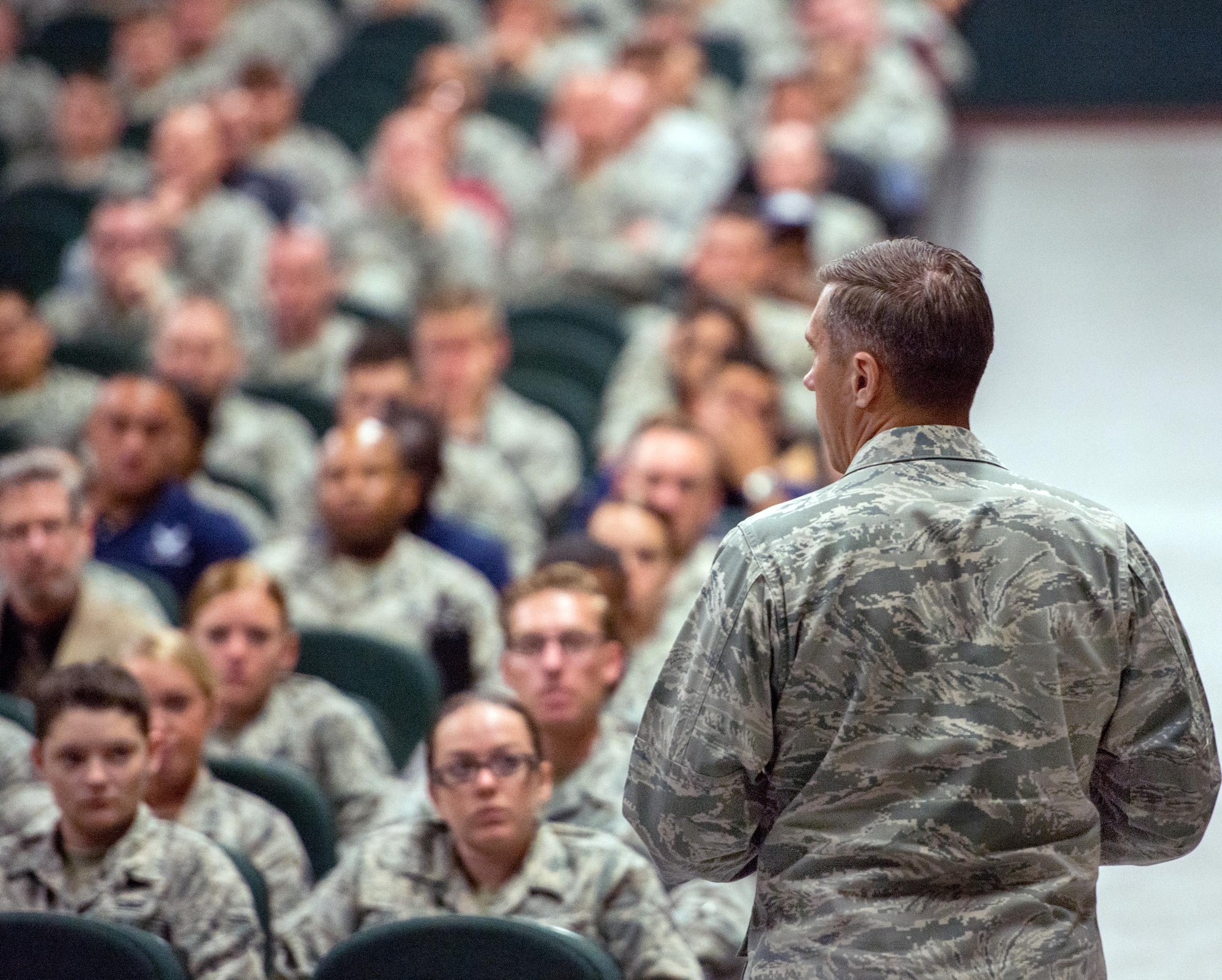 U.S. Air Force Col. John Klein, 60th Air Mobility Wing commander, gives a briefing during his commander’s call at Travis Air Force Base, Calif., August 8, 2017. Klein discussed a variety of topics to include safety, projecting American power and how every Airmen fits into the mission. (U.S. Air Force photo by Louis Briscese)