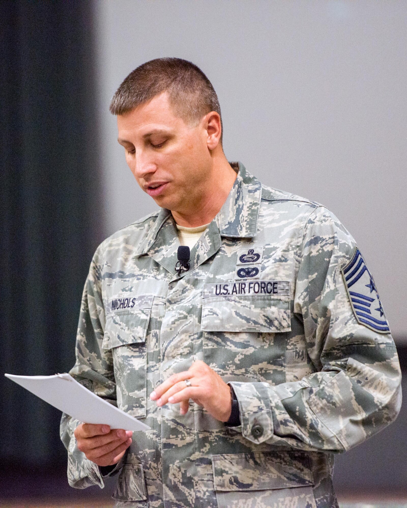 U.S. Air Force Chief Master Sgt. Steve Nichols, 60th Air Mobility Wing command chief, gives a briefing during a commander's call run by U.S. Air Force Col. John Klein, 60th AMW commander, at Travis Air Force Base, Calif., August 8, 2017. Klein and Nichols discussed a variety of topics to include safety, projecting American power and how every Airmen fits into the mission. (U.S. Air Force photo by Louis Briscese)