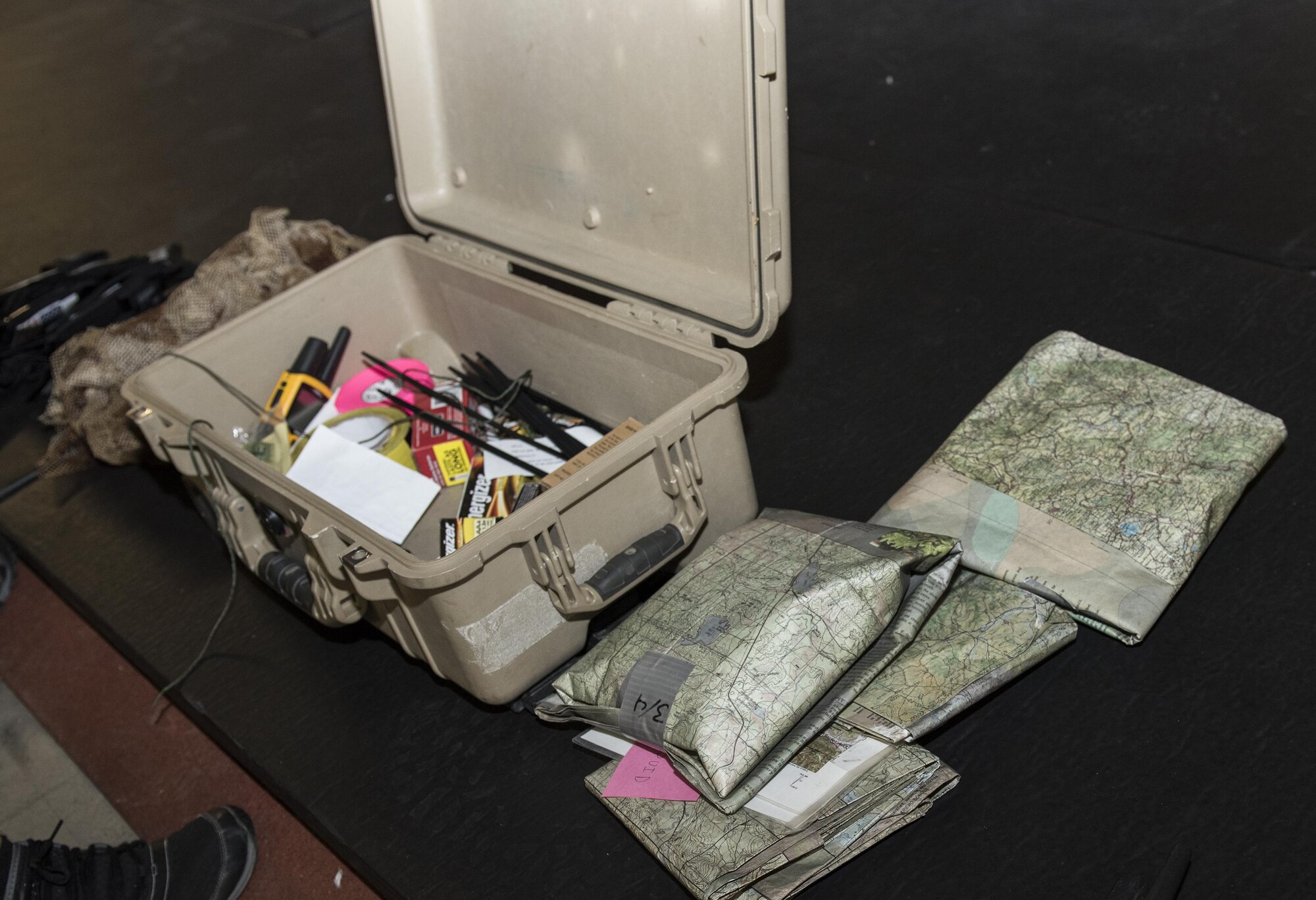 Communication devices and other supplies are prepared to be used for a U.S. Air Force Survival, Evasion, Resistance and Escape training session for aircrew members that will last well into the evening in a remote area near Travis Air Force Base, Calif., Jul. 17, 2017.