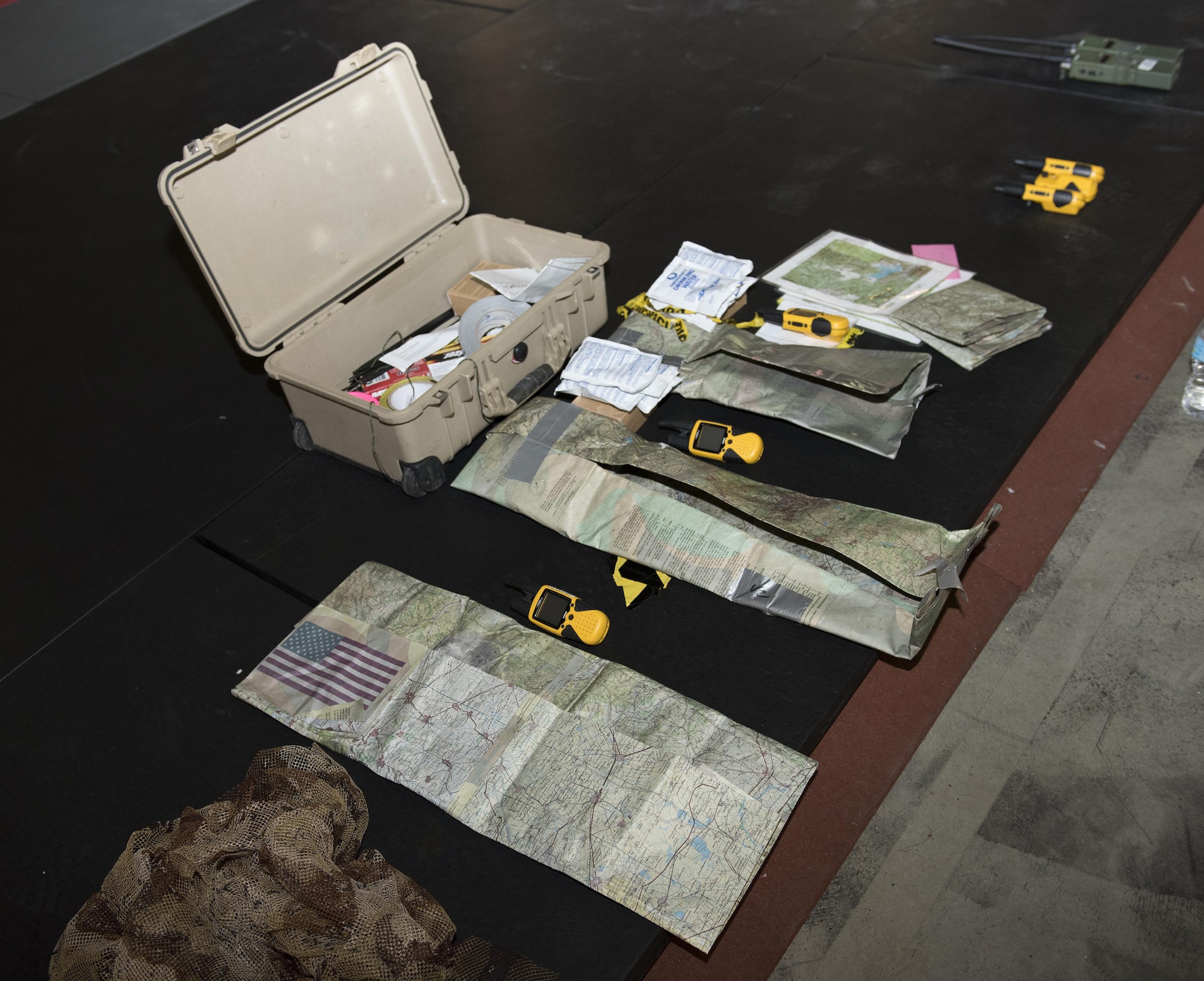 Communication devices and other supplies are prepared to be used for a U.S. Air Force Survival, Evasion, Resistance and Escape training session for aircrew members that will last well into the evening in a remote area near Travis Air Force Base, Calif., Jul. 17, 2017.