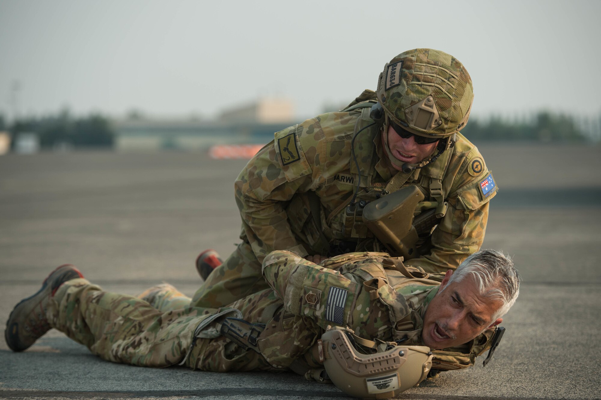 Royal Australian Air Force Leading Aircraftman Tobin Barwick, apprehends a role player during exercise Mobility Guardian at Moses Lake, Wash., Aug.7, 2017. Approximately 650 international service members will work alongside more than 3,000 U.S. service members during Mobility Guardian.  The exercise is Air Mobility Command’s premier readiness exercise, providing an opportunity for the Mobility Air Forces to train with joint and international partners in airlift, air refueling, aeromedical evacuation and mobility support.  (U.S. Air Force photo by Staff Sgt. Robert Hicks)