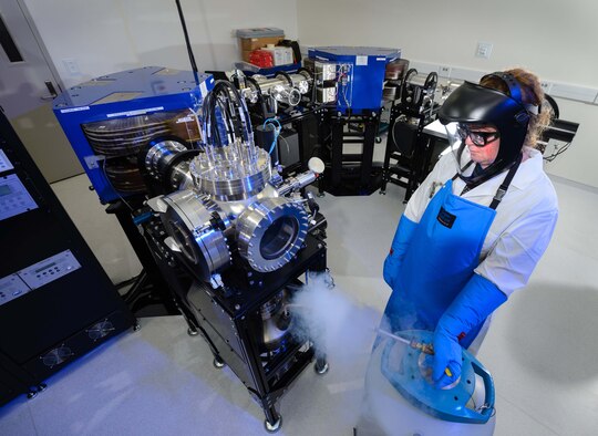Claudia Granger, a mass spectrometry technician at the Ciambrone Radiochemistry Laboratory, fills a liquid nitrogen trap in a thermal ionization mass spectrometer.  Granger is one of more than 1,000 people assigned to the Air Force Technical Applications Center at Patrick AFB, Fla., the Department of Defense’s sole nuclear treaty monitoring center. (U.S. Air Force photo by William B. Belcher)