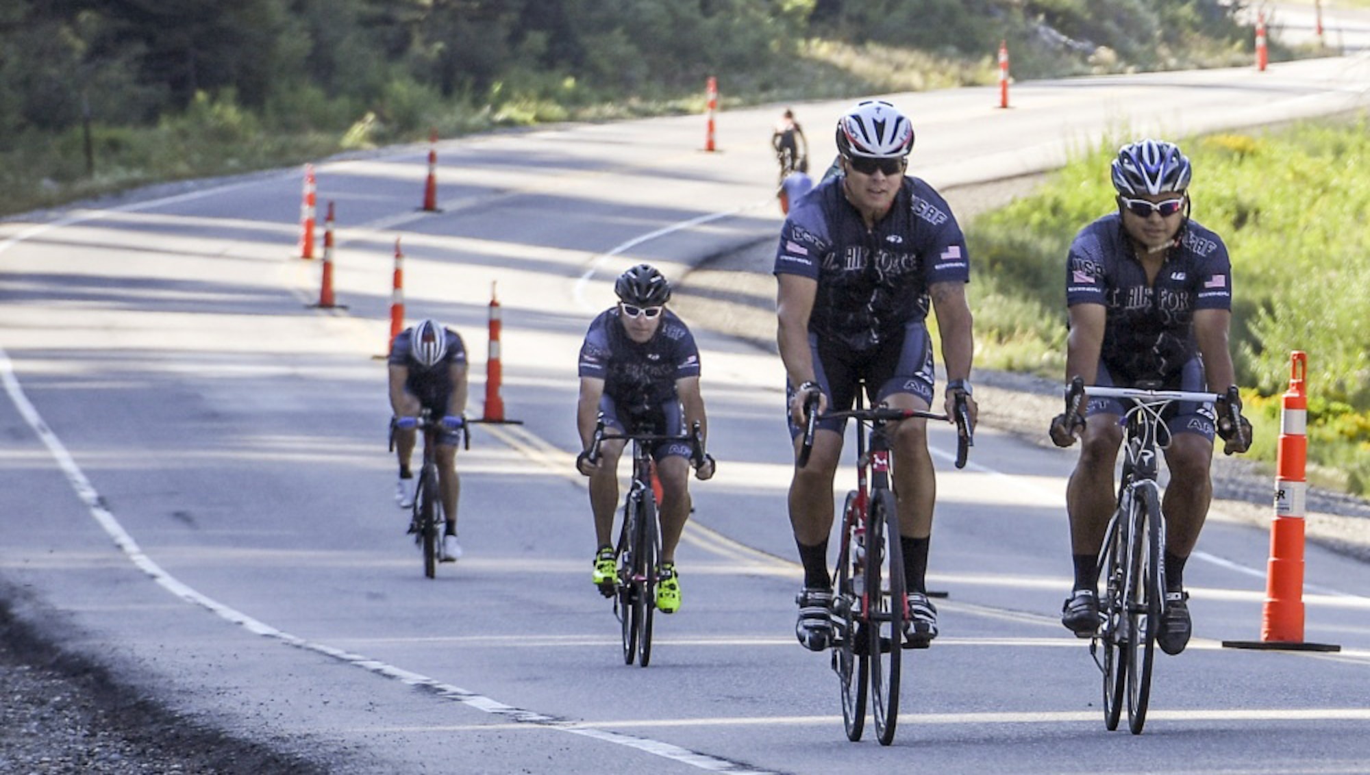 Master Sgts. Alex Duarte, Matt Train, Jeff Bernard and Mike Nuckols, all assigned to Hill Air Force Base, ride down Big Cottonwood Canyon, Utah, toward the Tour of Utah Stage 3 time trial starting chute Aug. 2.