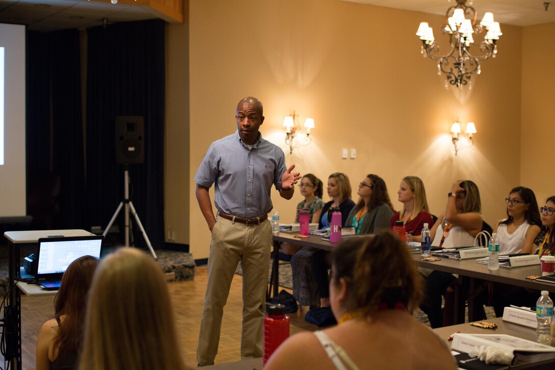 Sgt. Maj. Troy Nicks, Sergeant Major for 8th Marine Corps District speaks to spouses about recruiting during the District Spouses Orientation Course 2-17 at the Lone Star Center, August 8, 2017. More than 40 Marine spouses from throughout the district will learn about the demanding life of Marines on recruiting duty, be given resources to promote a successful recruiting tour and build camaraderie among other spouses. The DSOC introduces family members to the business of recruiting and helps them adapt to unique challenges encountered while on recruiting duty.