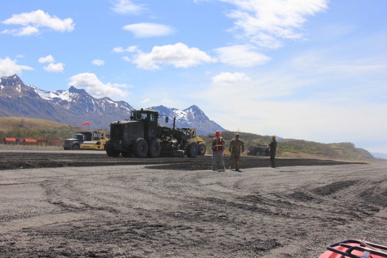 Reserve Marine and Army personnel oversee the extension of a runway during Integrated Readiness Training Old Harbor, June 1, 2017, in Old Harbor, Alaska. Marine Aircraft Group 41, 4th Marine Aircraft Wing, Marine Forces Reserve, led exercise IRT Old Harbor during which service members trained in a wide variety of skills while extending Old Harbor’s runway from 2,700 feet to 4,700 feet helping facilitate economic development.