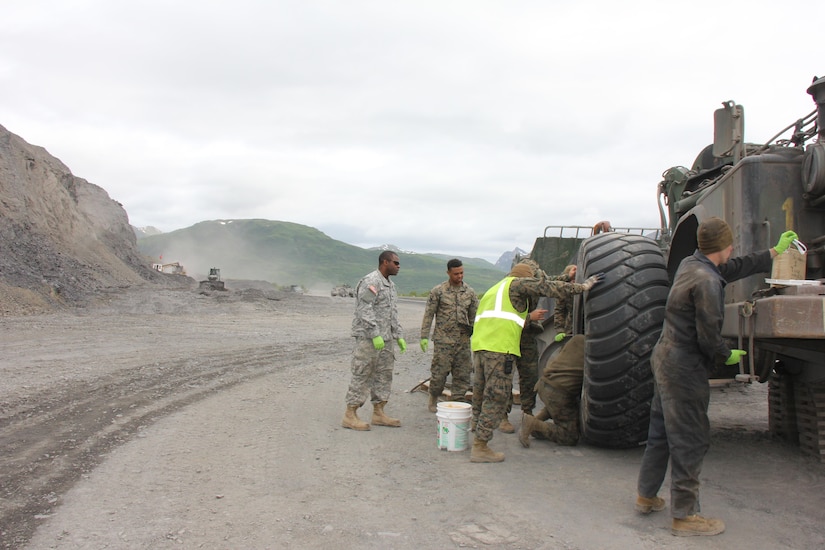 Reserve Marines and Army personnel work on heavy equipment.