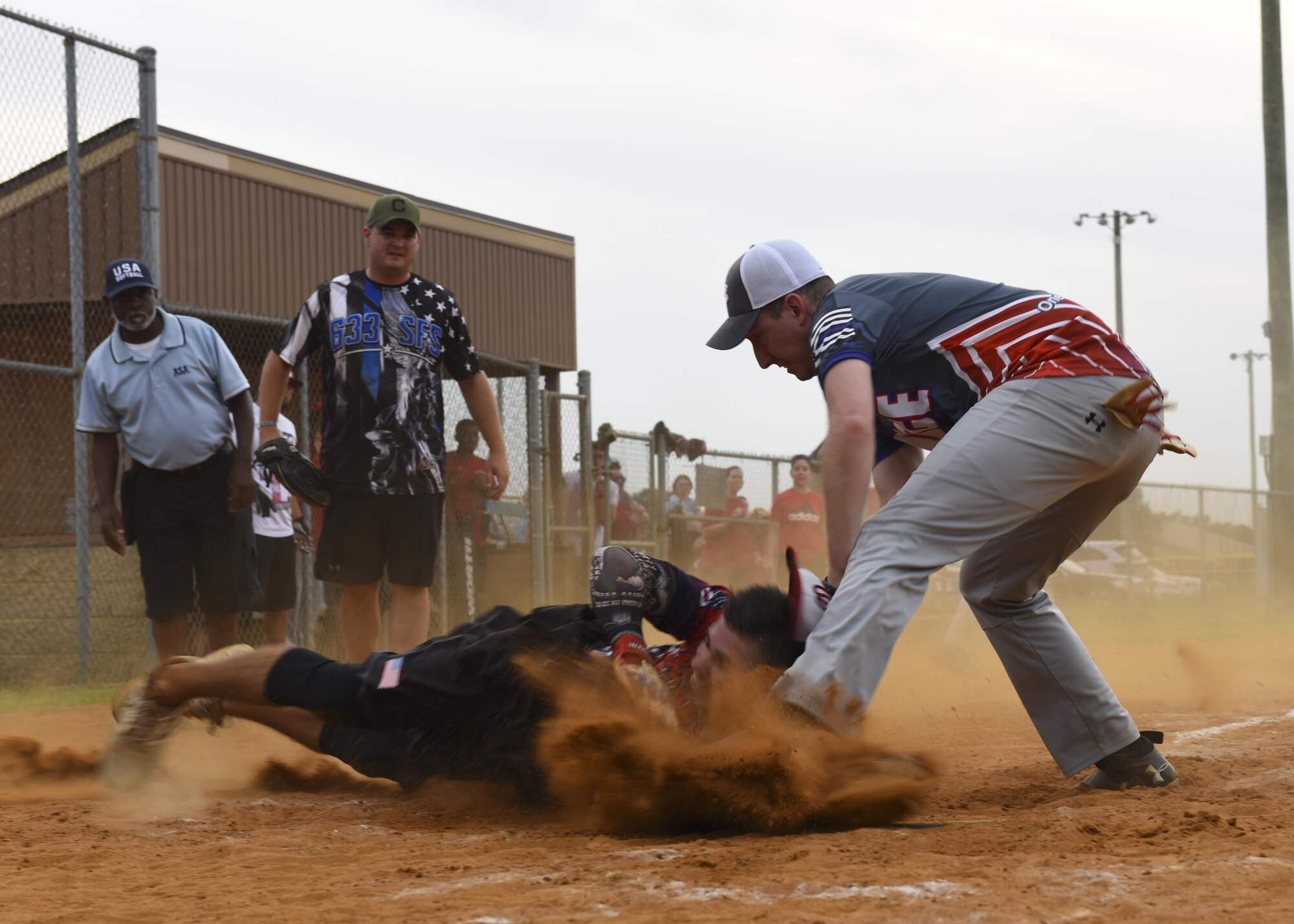 U.S. Air Force Senior Airman Mark Welch (right), 633rd Security Forces Squadron armorer, tags out Senior Airman Mark (center), 30th Intelligence Squadron geospatial analyst,during the Intramural Softball Championship at Joint Base Langley-Eustis, Virginia., August 1, 2017.