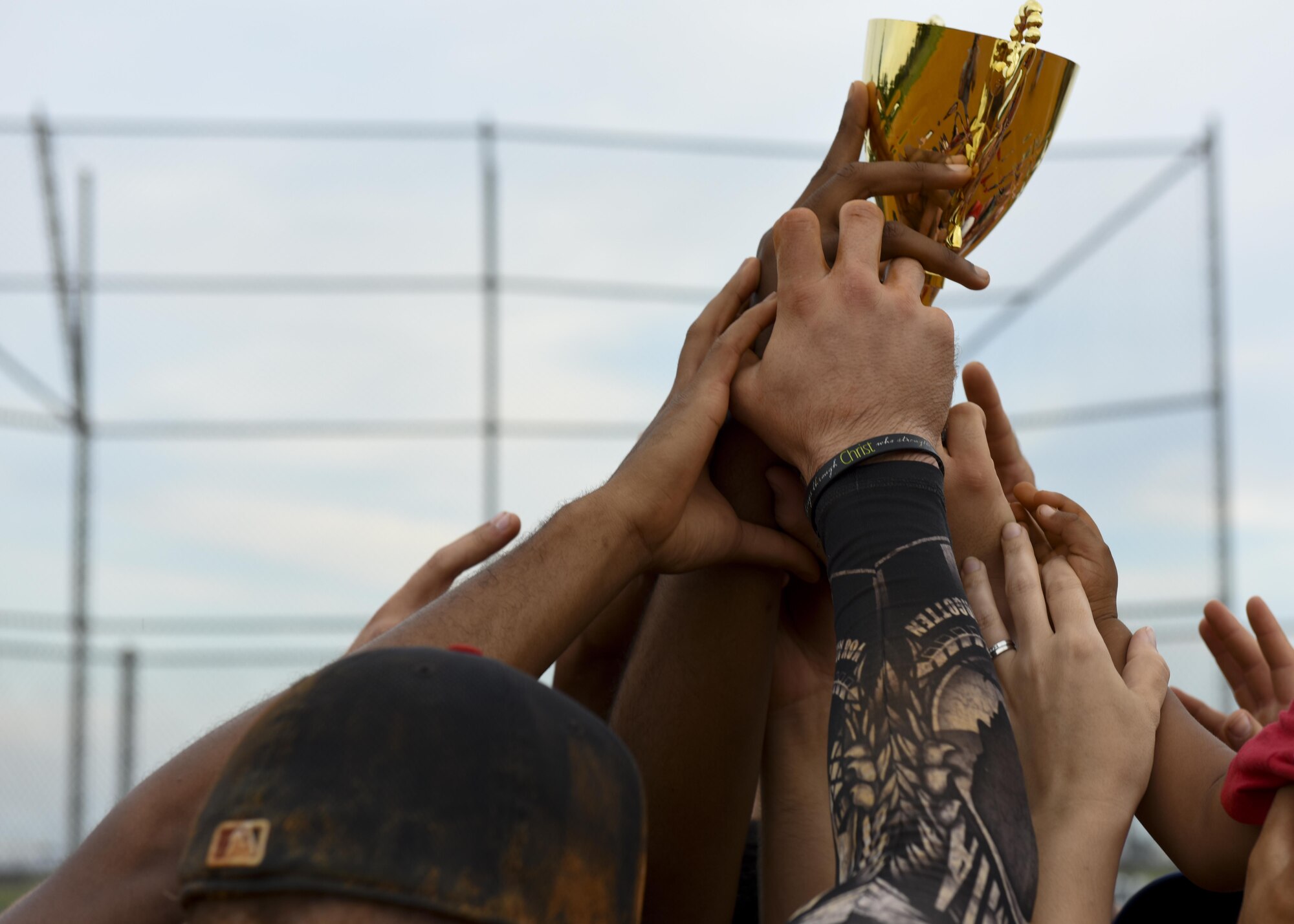 Members of the 30th Intelligence Squadron hoist the championship trophy after the Intramural Softball Championship at Joint Base Langley-Eustis, Virginia., August 1, 2017.
