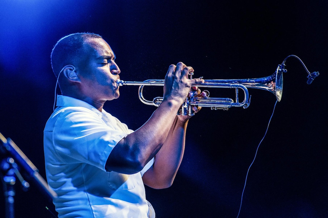 A sailor plays the trumpet.