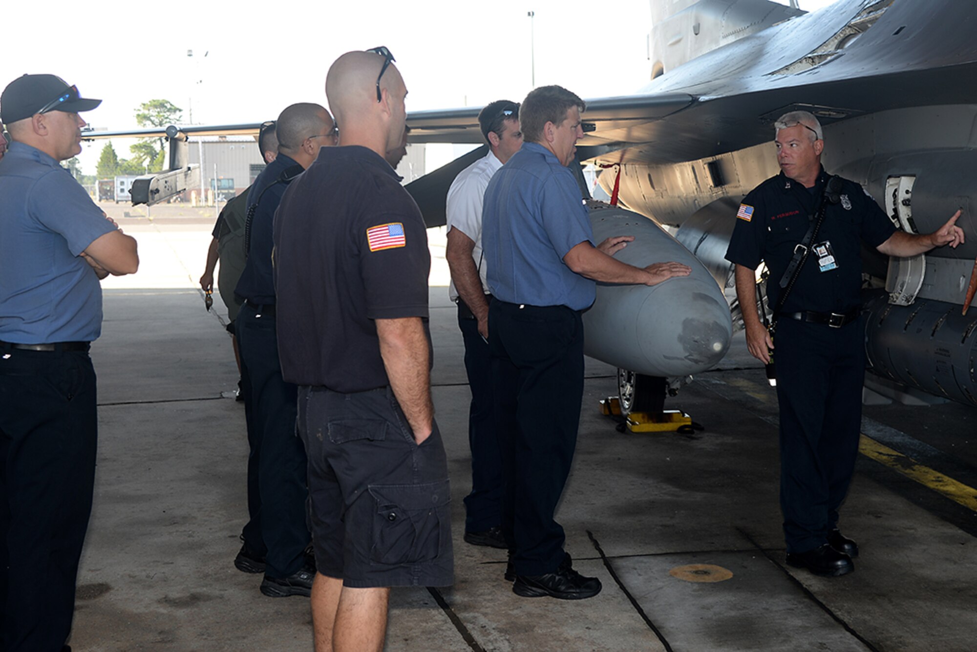 A picture of William Ferguson, a captain with the 177th Fighter Wing’s Fire Department, providing F-16 familiarization training to the Atlantic City Fire Department and the New Jersey State Police Technical Emergency and Mission Specialist Unit at the 177th Fighter Wing Fire Station.