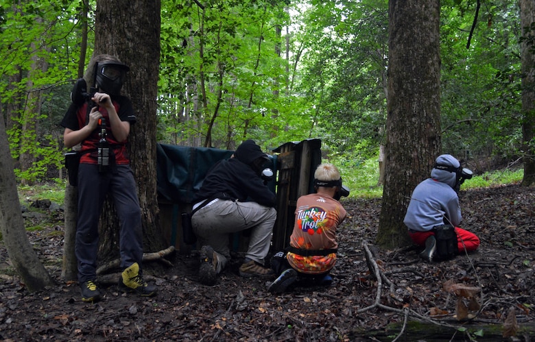 Teens take cover on the Vallley course at the MArine Corps Base Quantico Paintball Park.