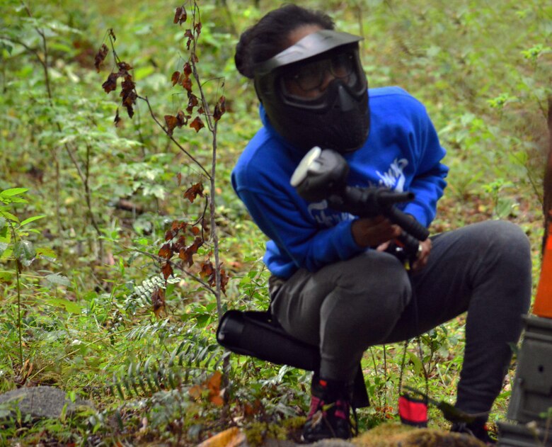 Teen scopes out the field at the Quantico Paintball Park's Valley course.