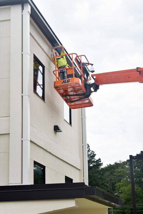 A contractor makes the final adjustments to the exterior of the Faith Wing in Anniston Ala. Recently completing the biggest part of the upgrades, the Mobile District has turned over the keys to a new 37,500-square-foot training center, a $9.4 million renovation project, known as Faith Wing, originally constructed in the 1950s, the project required demolition of the building down to the structure and was rebuilt as a high-end training area for the Department of Homeland Security.