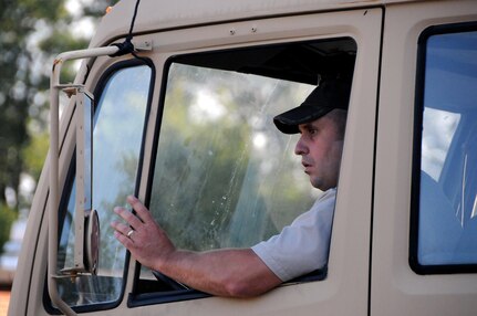 Seth Conoway, work leader at the U.S. Army Reserve's Area Maintenance Support Activity 112 in Lock Haven, Pennsylvania, backs-up a trailer August 8 loaded with a laundry advanced driver system.  AMSA 112’s mission is to maintain readiness by providing field-level maintenance support to six assigned Army Reserve units within its region, provide training to unit personnel and prepare equipment for mobilization.