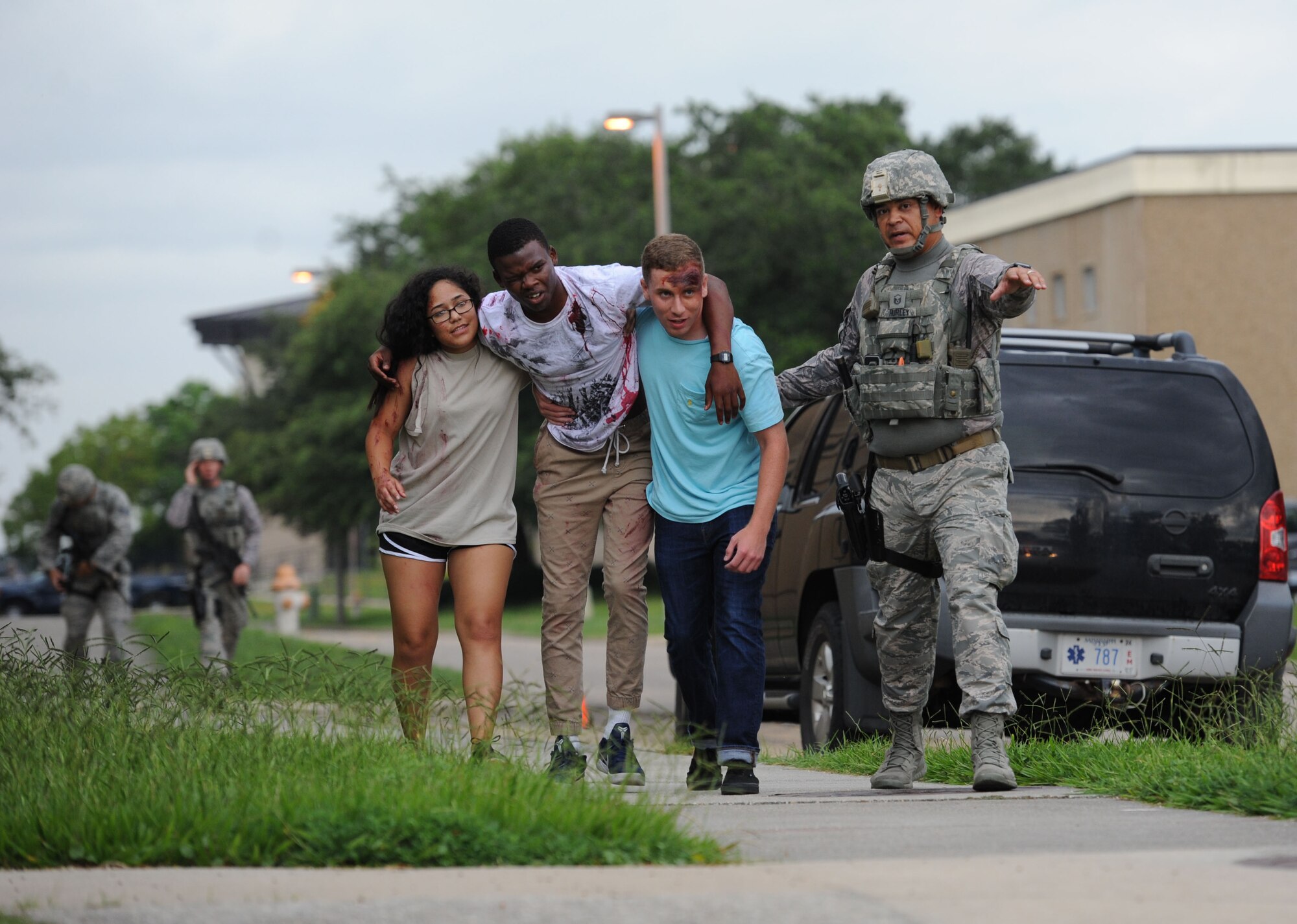 Master Sgt. Michael Hurley, 81st Security Forces Squadron flight chief, guides Airmen portraying “victims” to a triage area during an antiterrorism and Force Protection Condition exercise, Aug. 3, 2017, on Keesler Air Force Base, Miss. The scenario included a gate runner who plowed into a student formation causing mass casualties. Wing and safety personnel designed the exercise to prepare Keesler personnel for potential real world situations. (U.S. Air Force photo by Kemberly Groue)