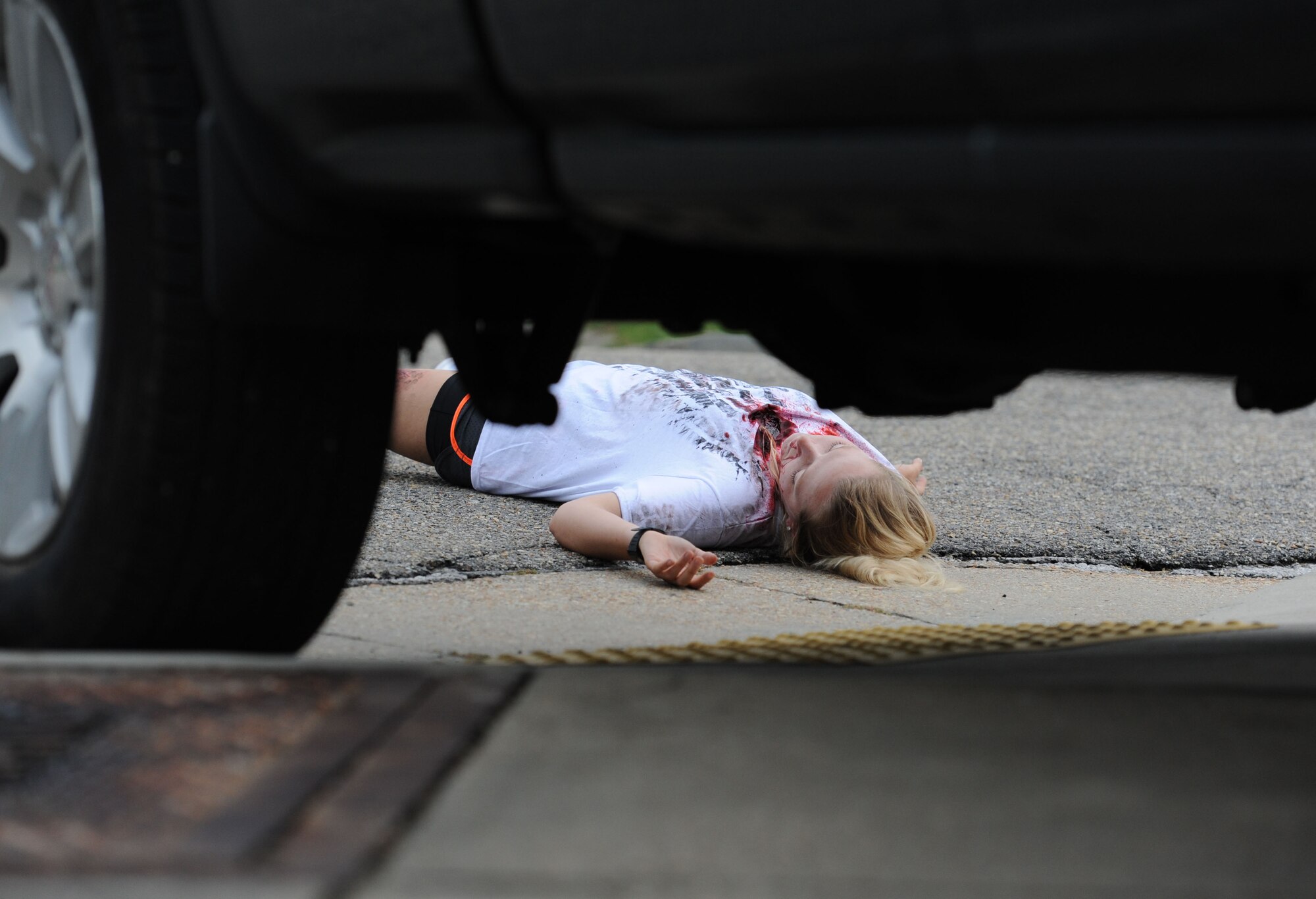 Airman Basic Breanne Bailey, 335th Training Squadron student, portrays a “victim” injured during an antiterrorism and Force Protection Condition exercise, Aug. 3, 2017, on Keesler Air Force Base, Miss. The scenario included a gate runner who plowed into a student formation causing mass casualties. Wing and safety personnel designed the exercise to prepare Keesler personnel for potential real world situations. (U.S. Air Force photo by Kemberly Groue)