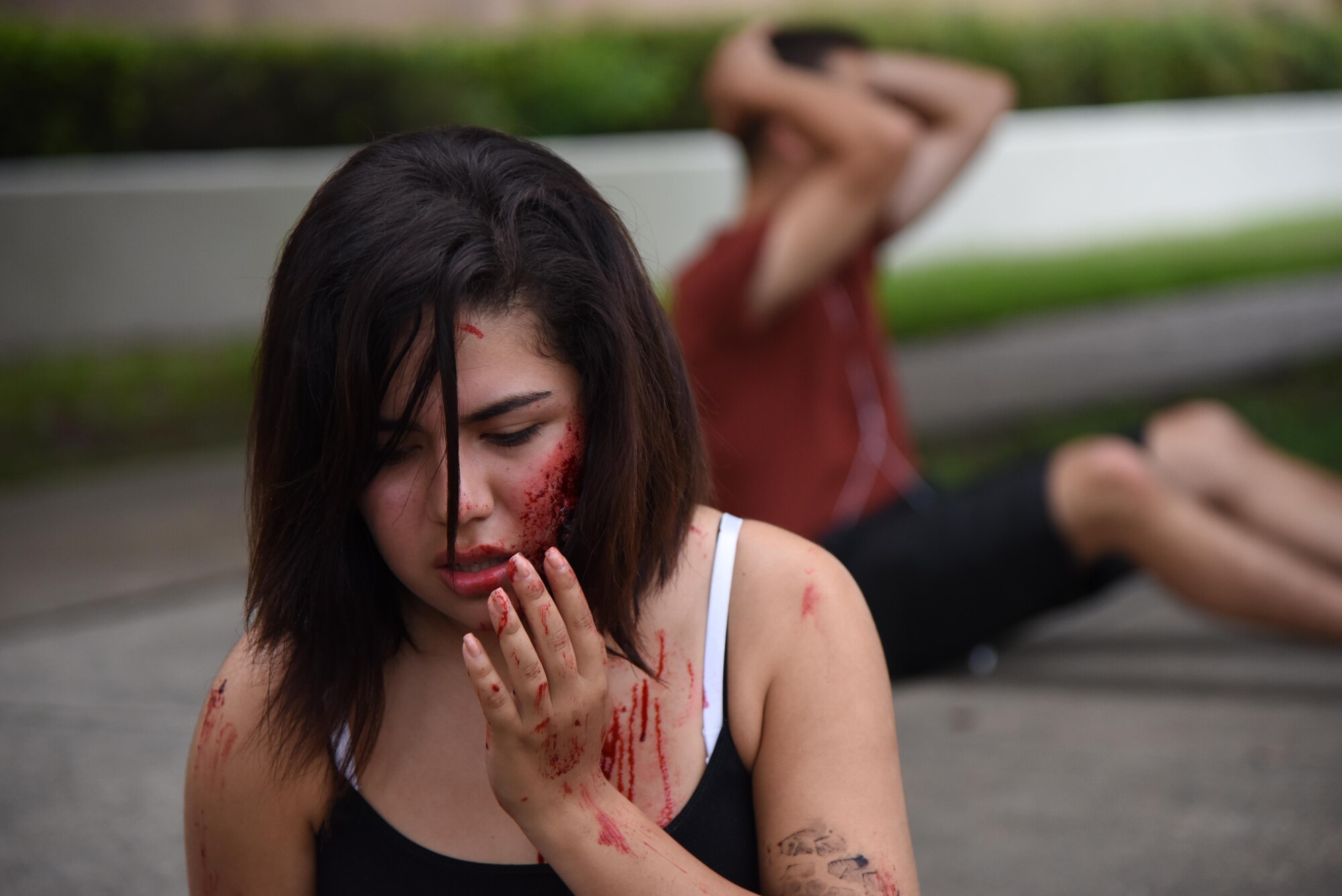 Airman Basic Stephanie Gonzalez, 335th Training Squadron student, portrays a “victim” injured during an antiterrorism and Force Protection Condition exercise, Aug. 3, 2017, on Keesler Air Force Base, Miss. The scenario included a gate runner who plowed into a student formation causing mass casualties. Wing and safety personnel designed the exercise to prepare Keesler personnel for potential real world situations. (U.S. Air Force photo by Kemberly Groue)