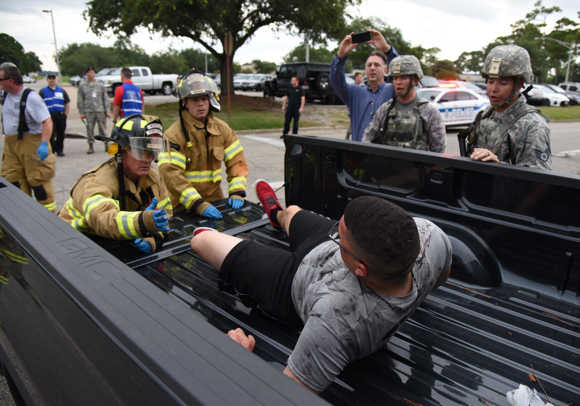 Keesler first responders assist Airman 1st Class Esteban Cruz, 335th Training Squadron student, as he portrays a “victim”  injured during an antiterrorism and Force Protection Condition exercise, Aug. 3, 2017, on Keesler Air Force Base, Miss. The scenario included a gate runner who plowed into a student formation causing mass casualties. Wing and safety personnel designed the exercise to prepare Keesler personnel for potential real world situations. (U.S. Air Force photo by Kemberly Groue)