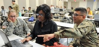 Sgt. Alberto Gonzalez, ESRB instructor with U.S. Army Reserve Command G-1 (right), assists Pamela Kone, unit administrator for the Army Reserve's 399th Transportation Detachment (center) and Spec. Miranda Behringer, human resources specialist with the Army Reserve's 432nd Civil Affairs Battalion, during Interactive Personnel Electronic Records Management System and Automated Record Brief training hosted by the Army Reserve’s 99th Regional Support Command Aug. 24-28 on Joint Base McGuire-Dix-Lakehurst, New Jersey.