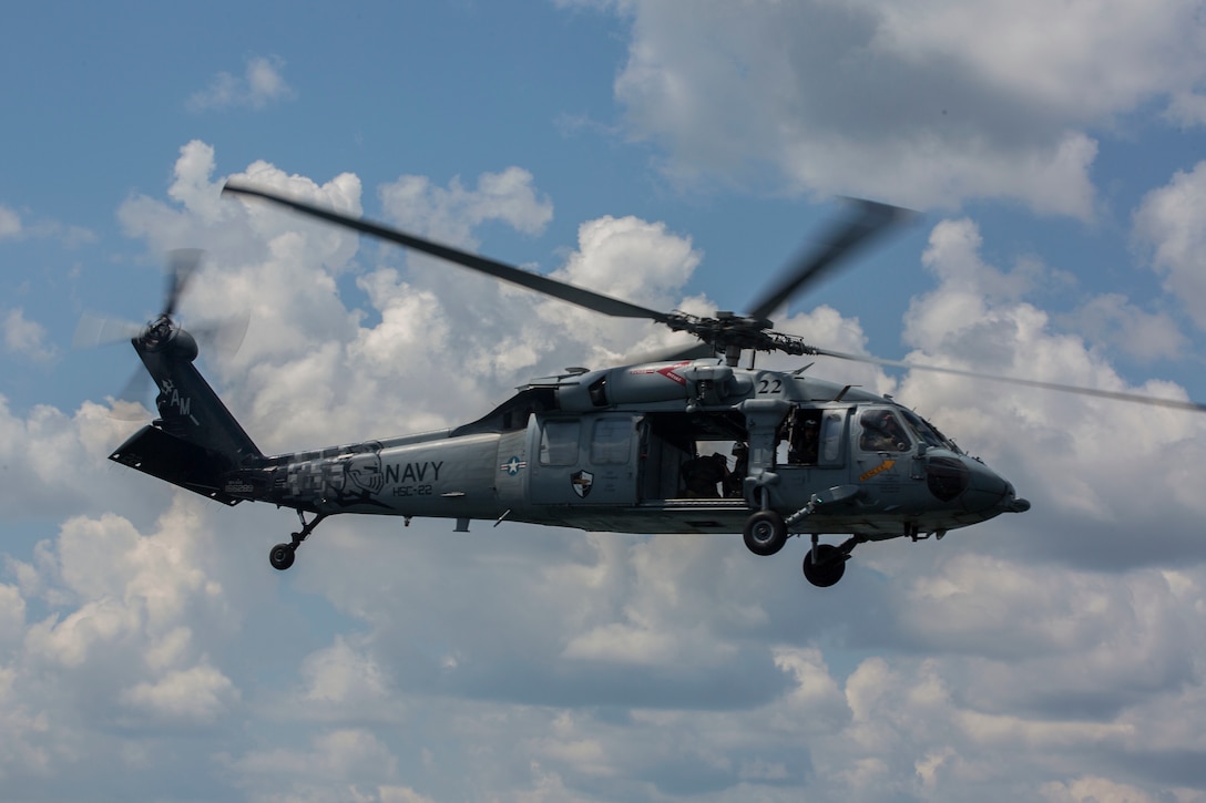 A Sikorsky SH-60 Seahawk with Helicopter Sea Combat Squadron 22, departs after inserting U.S. Marines with Echo Company, 4th Reconnaissance Battalion, 4th Marine Division, Marine Forces Reserve into Lake Margrethe, Camp Grayling Joint Maneuver Training Center, Michigan on July 31, 2017.